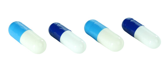 Bulk blue and white capsule pills isolated on white background.
