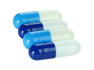 Bulk blue and white capsule pills isolated on white background.