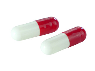 Bulk red and white capsule pills isolated on white background.