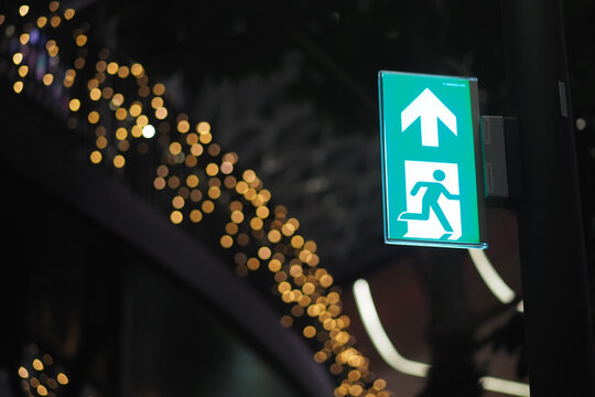 Emergency exit sign illuminated at night in urban area