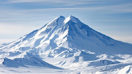 Majestic snow-capped mountain peak under a clear blue sky.