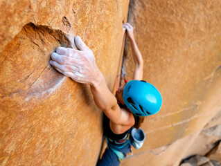 An experienced climber ascends a rocky face, showcasing skills and determination under clear skies in a breathtaking natural landscape. Generative AI.