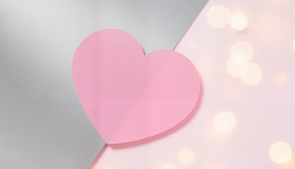 Pink heart on soft pastel background with sparkling lights  