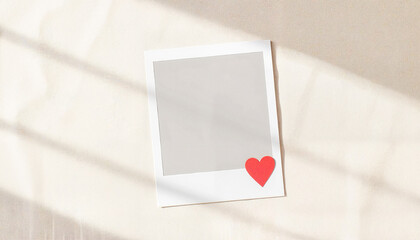 Blank photo frame with red heart design on textured background  