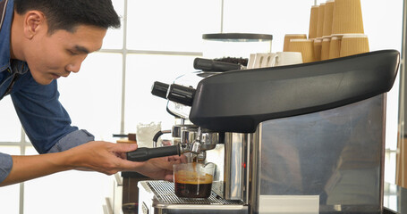 Coffee barista man make espresso shot from coffee maker hot cup. Cappuccino with milk in italian...