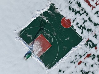 The school's basketball court in winter, the basketball court is covered with snow