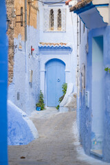 Naklejka premium Blue washed doorways in the old town Medina area of Chefchaouan located in the Rif Mountains of northwest Morocco