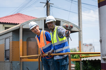 Engineers Team Working on a Train at a Rail Yard, Railroad Workers with Walkie-Talkie on Duty,...