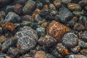 rocks under ocean ripples