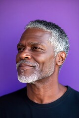 Obraz premium A midlife man with charm and elegance. A professional studio photography session of a stunning man. An expressive and modern man in a studio setting. A handsome man in his 40s with a radiant sm.