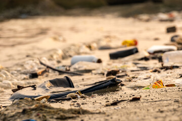 trash, plastic cups and plastic bags at the beach.environmental problem concept and healing the...