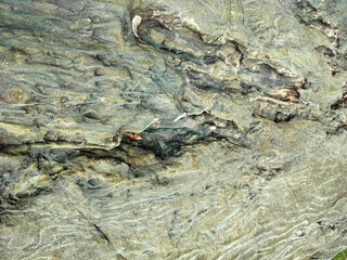 Textured stone background with rough rock wall surface, abstract natural grunge detail of stone material