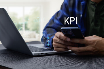 Businessman Analyzing KPI Performance with Laptop and Smartphone