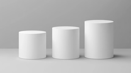 Three white cylindrical podiums against a neutral background.