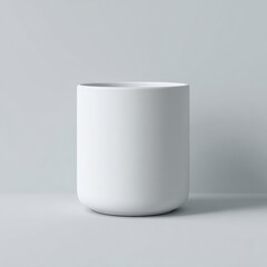 Empty white cylindrical planter on a light gray background