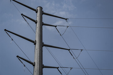 an electrical power line structure isolated against the blue sky abstract background. concept for...