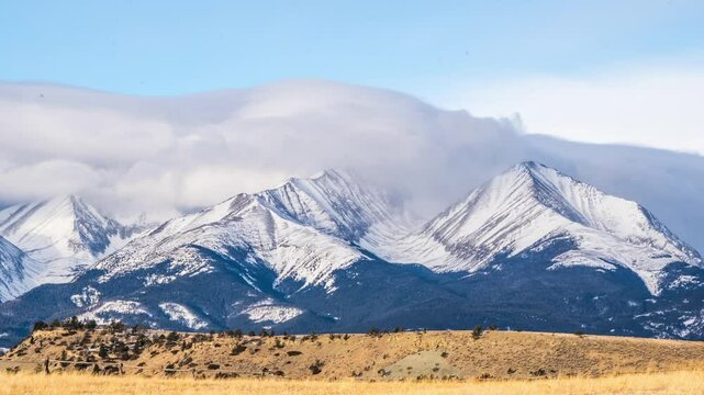 Clouds spilling over Crazy Mountains winter 