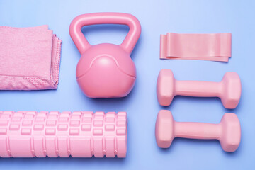 Set of sports accessories on blue background close-up top view.