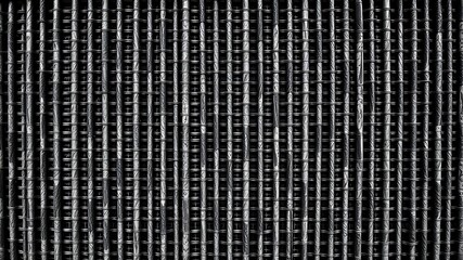 Metallic woven mesh texture showing detailed weaving pattern and industrial background design