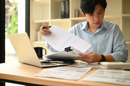 Cropped image of An Asian Auditor Reviewing Company Budget and Financial Data