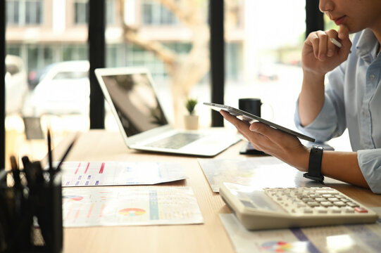 A Cropped image of a professional man analyzes marketing data, strategies, and KPIs to optimize digital campaigns