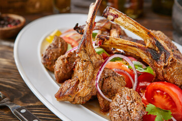 Venison rack and medallions, rustic warm lighting, overhead restaurant presentation