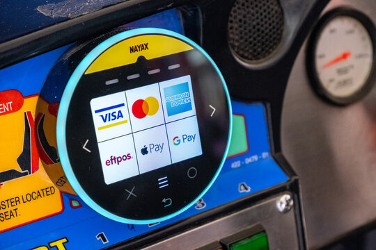 A contactless payment terminal on an arcade machine in Australia with touchscreen interface displays payment options logos including Visa, Mastercard, American Express, eftpos, Apple Pay, and Google 