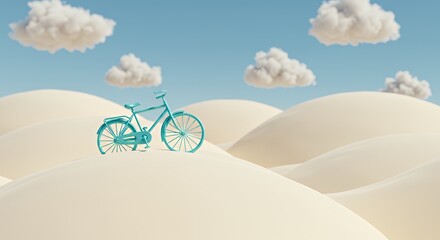 Turquoise bicycle on sand dune with blue sky and white clouds