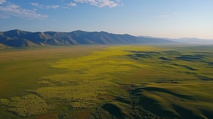 Fototapeta premium Vast, colorful, arid plains stretching to distant mountains
