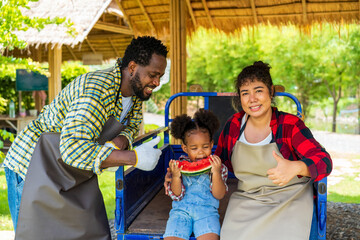A family of farmers is enjoying the harvest in their farm.