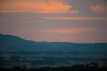 Sunset over wind turbines with farm land in the foreground, Camperdown, Victoria, Australia