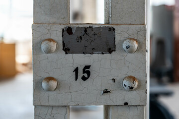 Abandoned industrial hall with old furniture, metal parts, and dusty workspaces. Atmospheric lost...