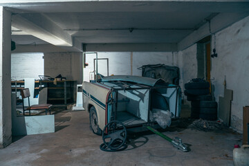 Abandoned industrial hall with old furniture, metal parts, and dusty workspaces. Atmospheric lost...