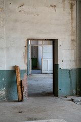 Abandoned industrial hall with old furniture, metal parts, and dusty workspaces. Atmospheric lost...