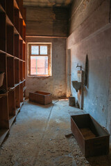 Abandoned industrial hall with old furniture, metal parts, and dusty workspaces. Atmospheric lost...