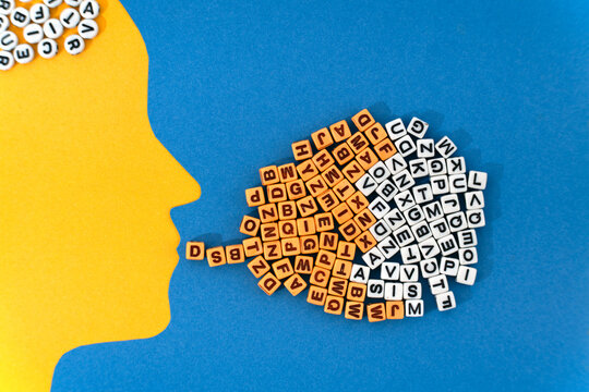 A paper-cut head with a cascade of letters flowing from its mouth symbolizing the transfer of ideas, emotional expression, and the complexity of human communication