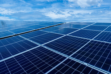 Wide view of blue solar panels under clear sky, photovoltaic cells for clean renewable energy production, sustainable technology and eco-friendly power generation system in outdoor solar farm.