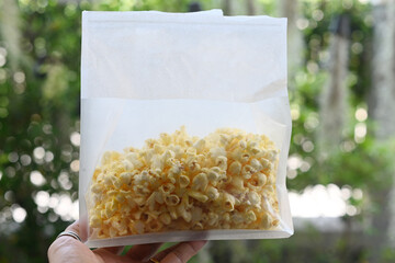 Butter-flavored popcorn in a white bag.