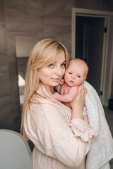 Beautiful woman holding a newborn baby in her arms