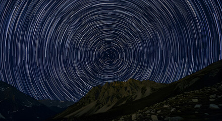 Star trails over mountains, a beautiful night sky with celestial movement