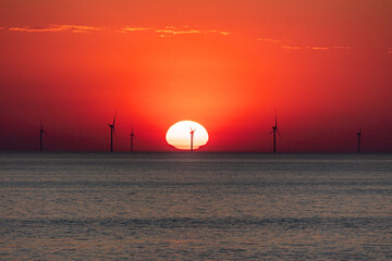 Offshore wind farm in the North Sea near to Egmond aan Zee generating renewable energy at sunset