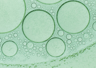 Macro microscope green bubble texture, Close-up Green bubbles and drops oil background . blue green water bubbles, close up golden oil drop for cosmetic