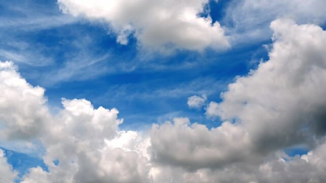 Vibrant Blue Sky with Fluffy White Clouds on a Sunny Day