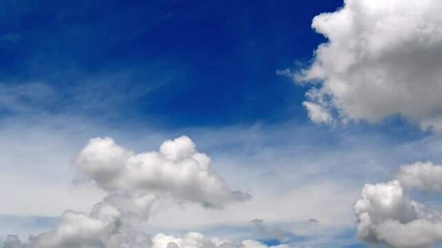 Bright Blue Sky with Fluffy White Clouds and Sunshine Atmosphere