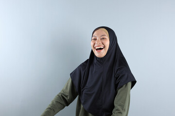 Beautiful Muslim Woman Wearing Black Hijab, Green Sage Blouse Smiling and Looking Back