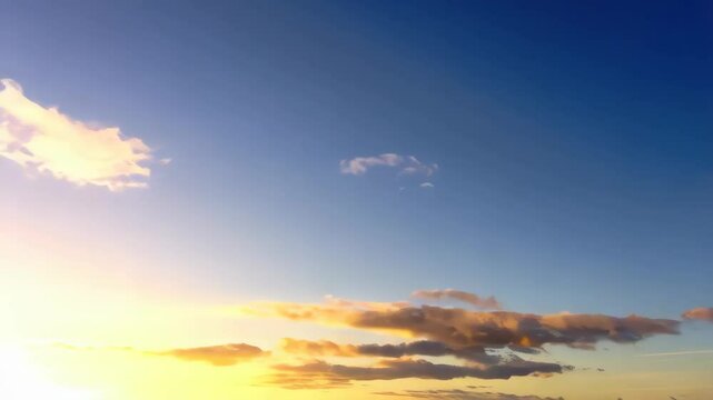 Softly lit altocumulus clouds fill a blue sky at sunrise or sunset, providing a natural and tranquil scene.