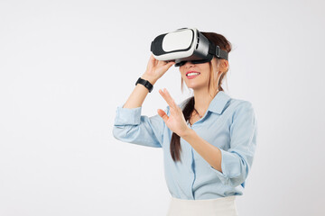 Asian woman with vr headset glasses touches virtual reality future game, businesswoman explores new digital worlds wearing vr goggles for interaction with a white screen, isolated white background