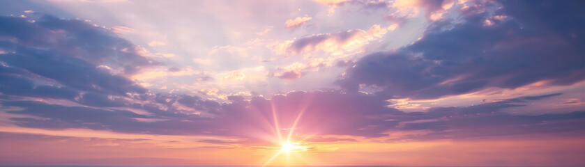 Purple sky sunset with sun rays shining through clouds creating peaceful atmosphere