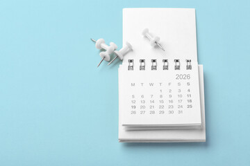 Calendar 2026 with white pins on light blue background, business schedule, planner, reminder concept