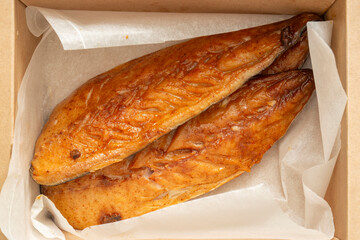 Honey glazed smoked mackerel fillets in a brown cardboard box lined with greaseproof paper. Recycle biodegradable eco friendly retail packaging.